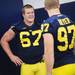 Michigan junior defensive tackle Nathan Brink smiles while chatting with teammate sophomore defensive end Brennen Beyer during media day at the Al Glick Field House on Sunday afternoon. Melanie Maxwell I AnnArbor.com